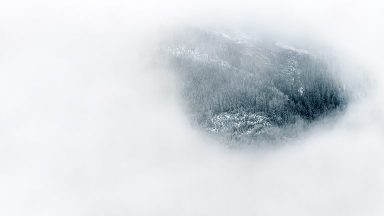 Glimpse of the landscape below through a cloud cover